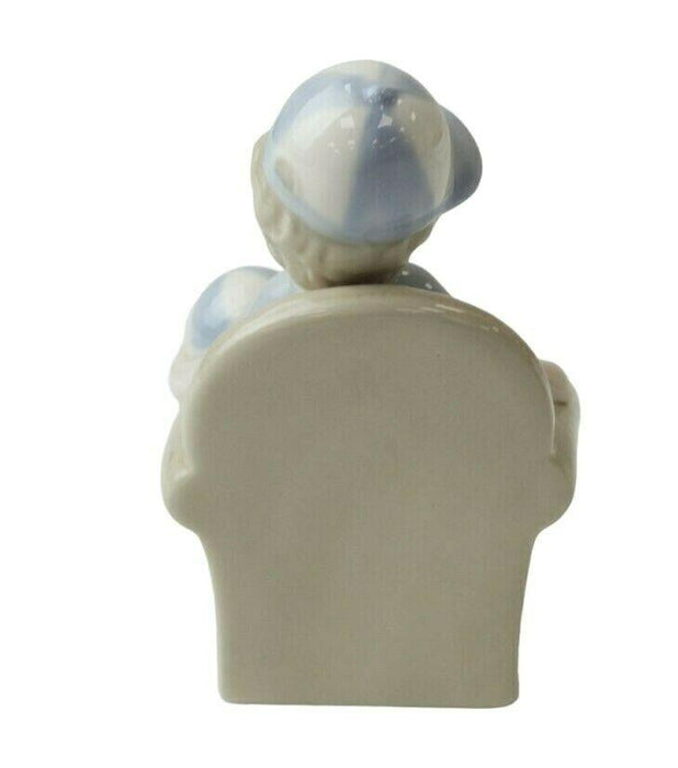 Little Boy Figurine - Young Child On Couch Small Porcelain Shelf Ornament 10.5cm