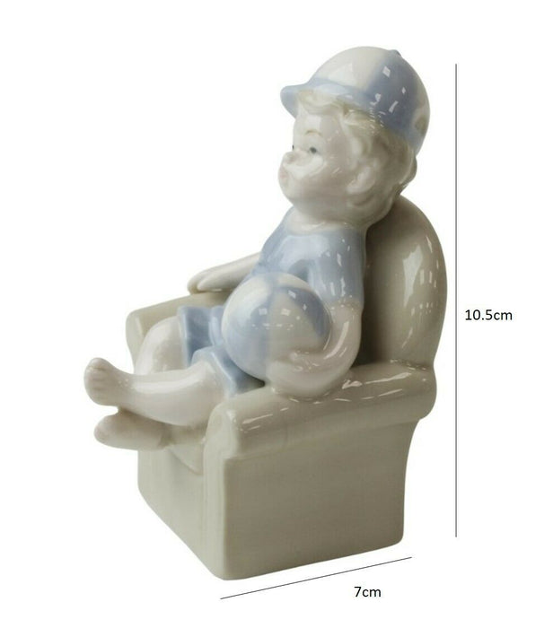 Little Boy Figurine - Young Child On Couch Small Porcelain Shelf Ornament 10.5cm